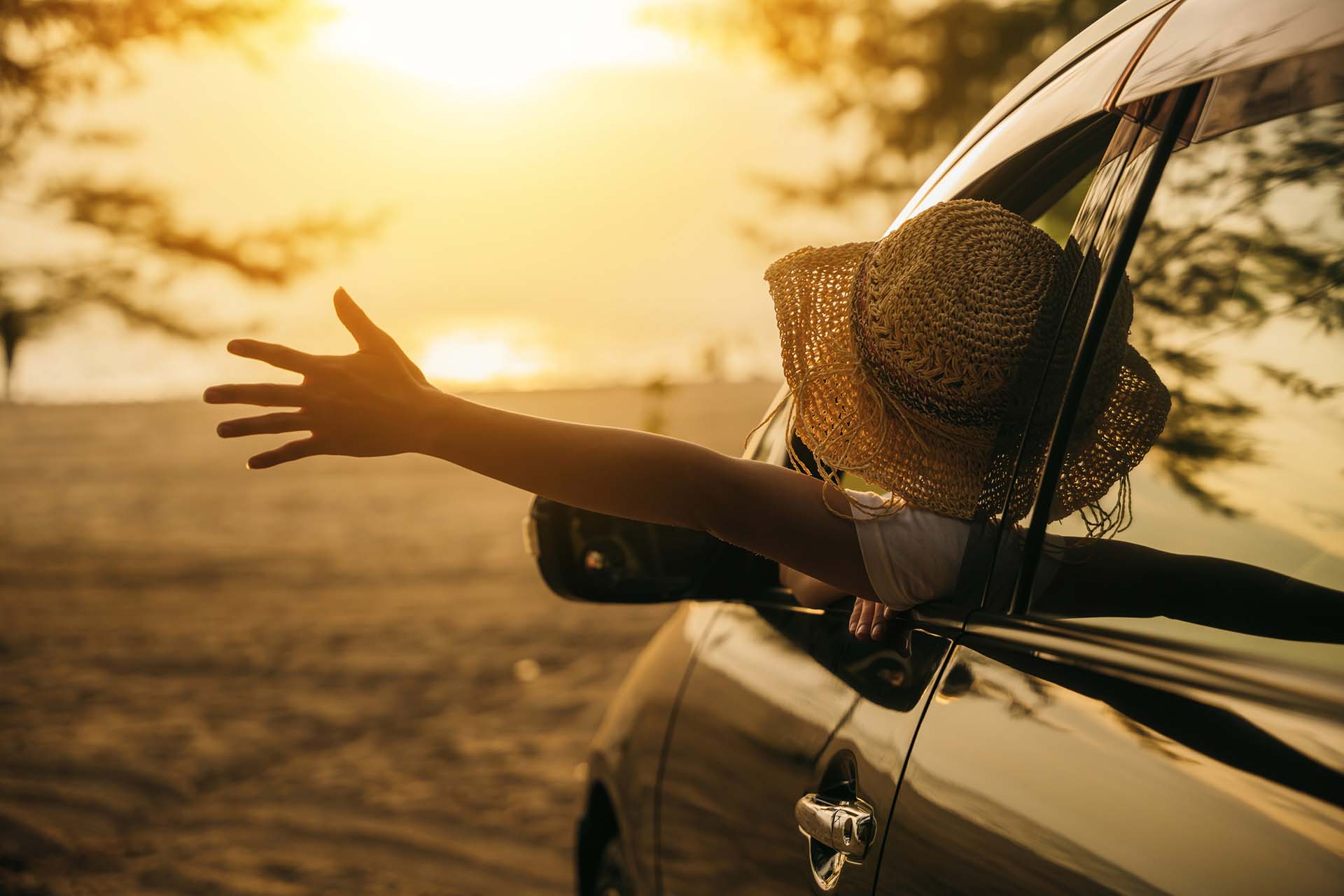 AutoRhodes Car Rental girl waving her car out of the window